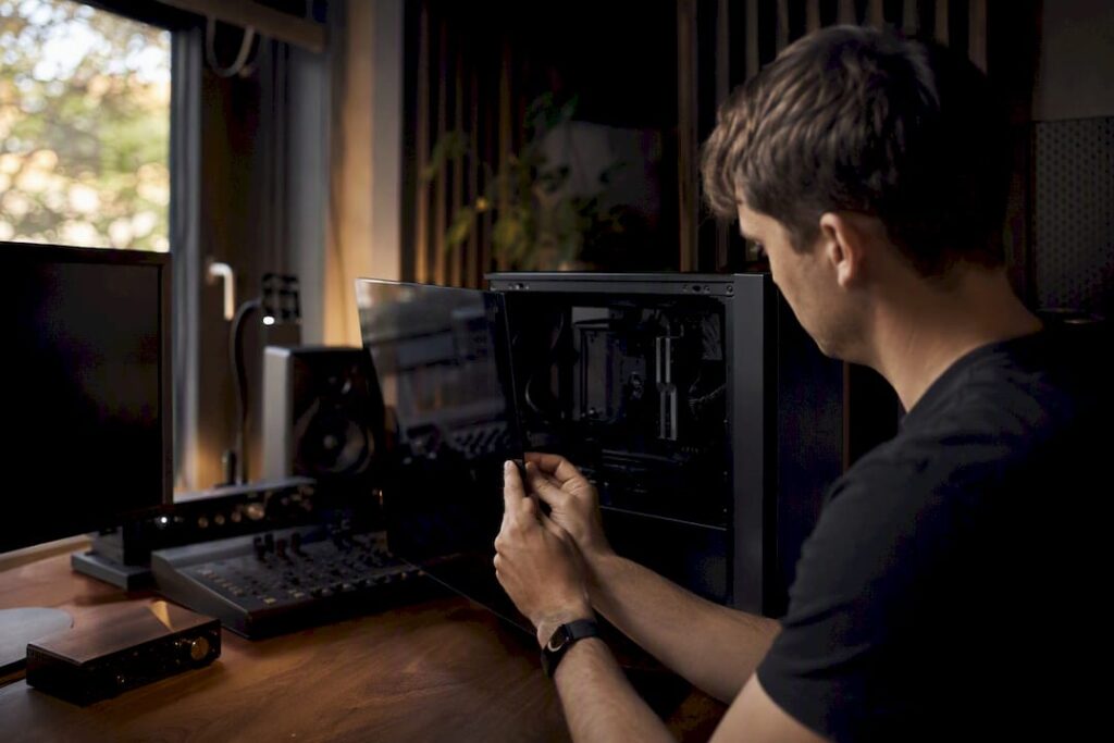 Iemand start zijn studio-pc op om problemen met de plugins op te lossen.