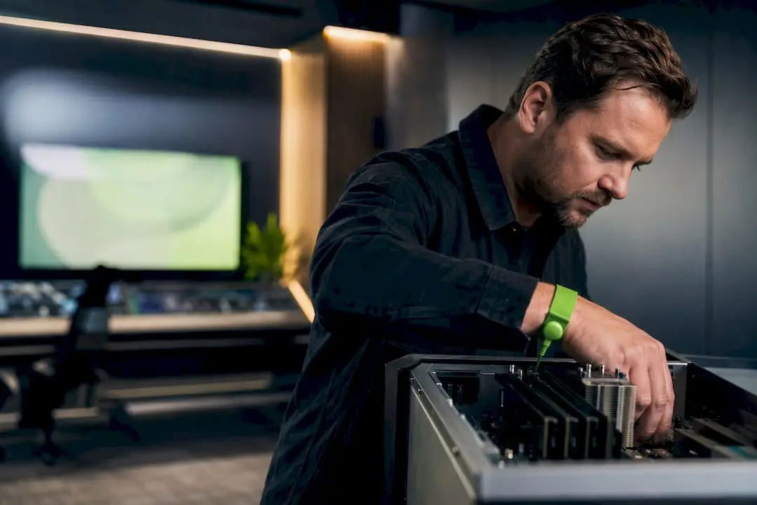 Custom-built computer for local radio and television: what specs matter 8 Technician inspects custom-built hardware for broadcast